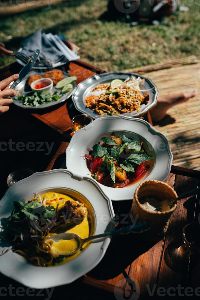 Delicious soup and other food on the table photo