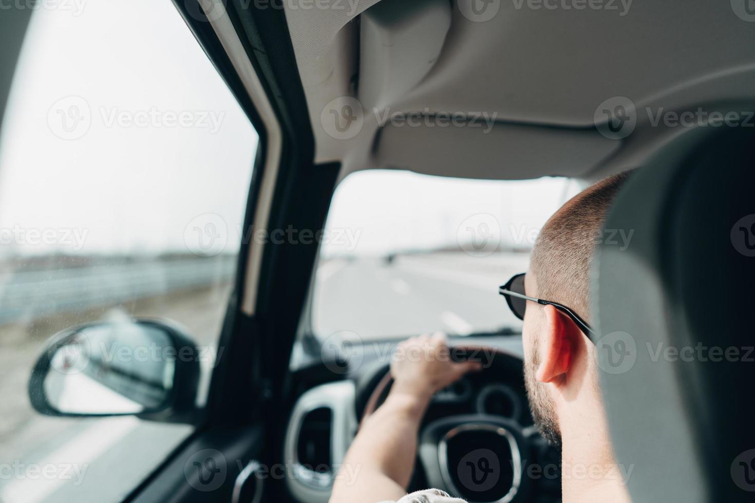 The man in the car traveling on the road photo