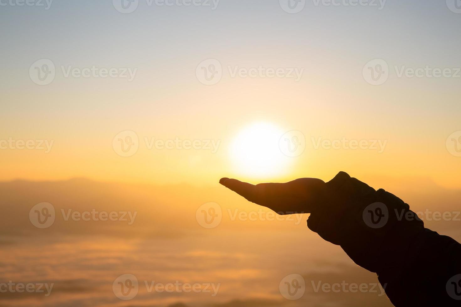 Silhouette of a woman with hands raised in the sunset concept for religion, worship, prayer and praise, Religious concepts photo