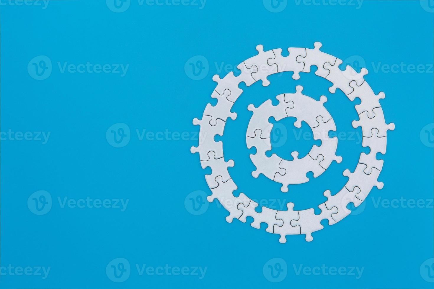 White jigsaw puzzle on blue background, Copy space. photo