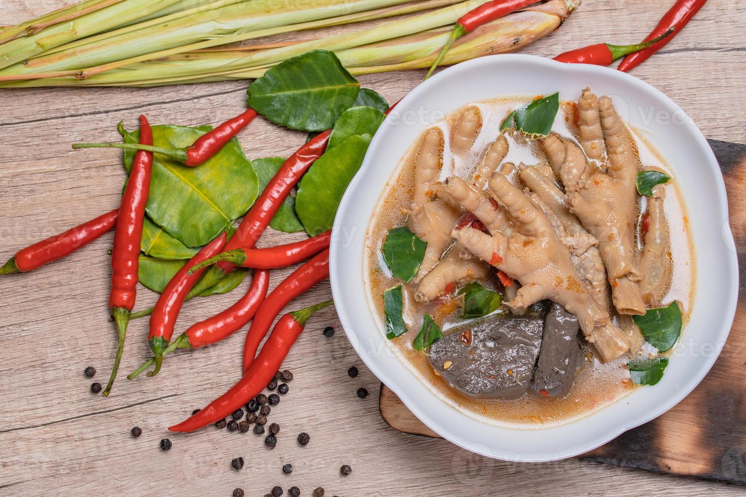 Spicy Stewed Chicken Feet Tom Yum with Fresh Chili, Lemongrass, Kaffir Lime Leaves photo