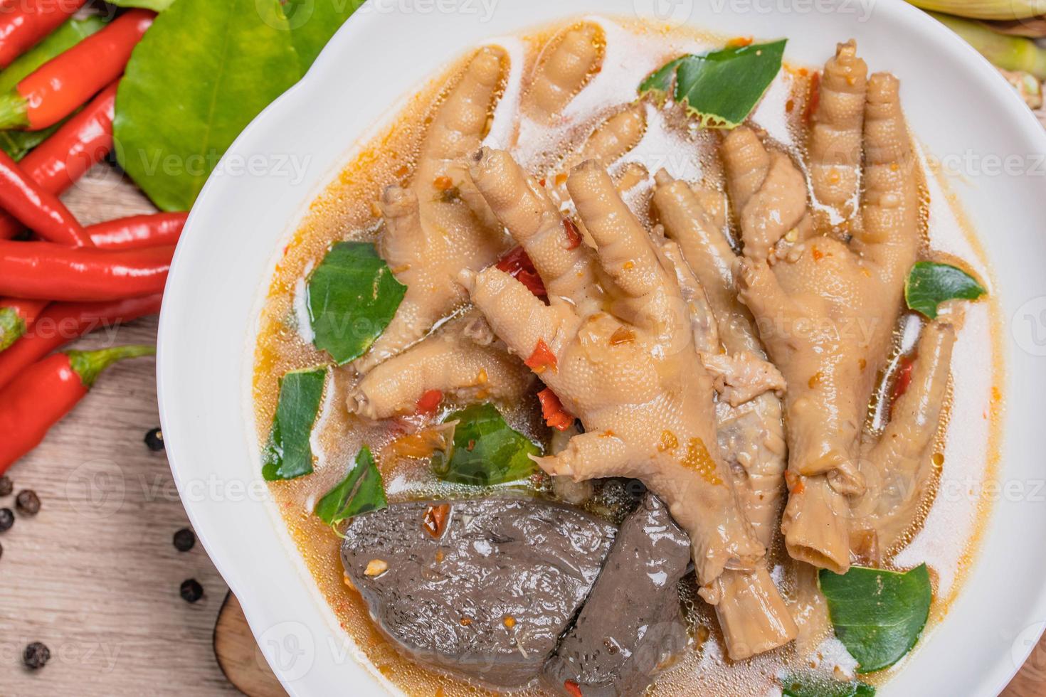 Spicy Stewed Chicken Feet Tom Yum with Fresh Chili, Lemongrass, Kaffir Lime Leaves photo