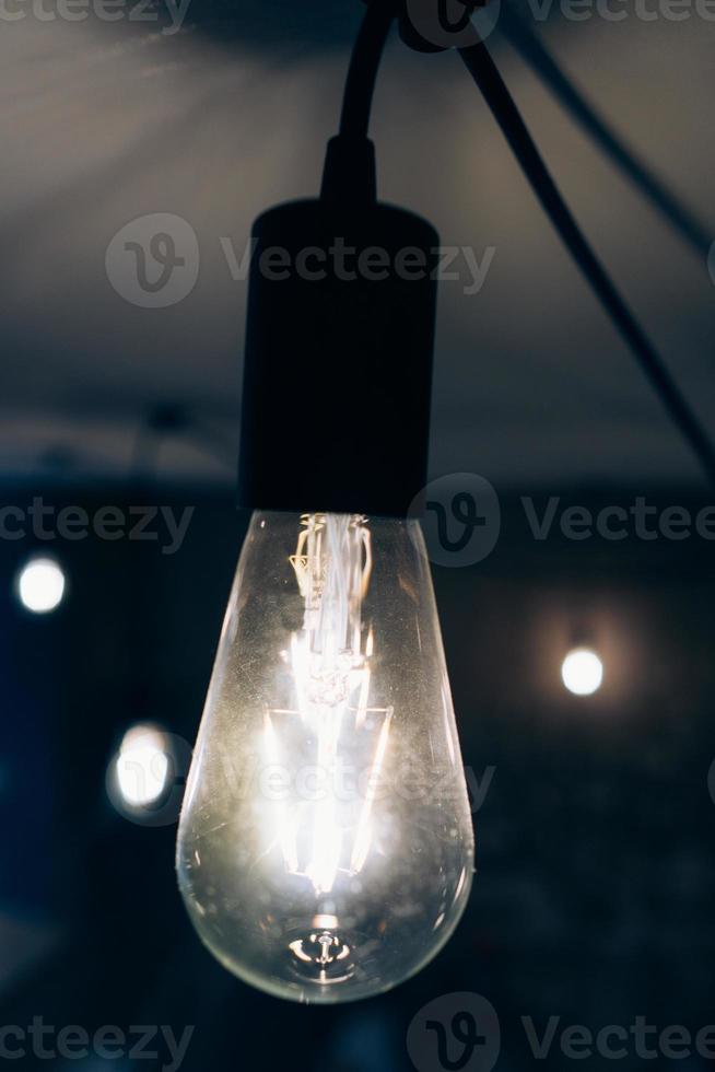 Burning an incandescent edison lamp photo