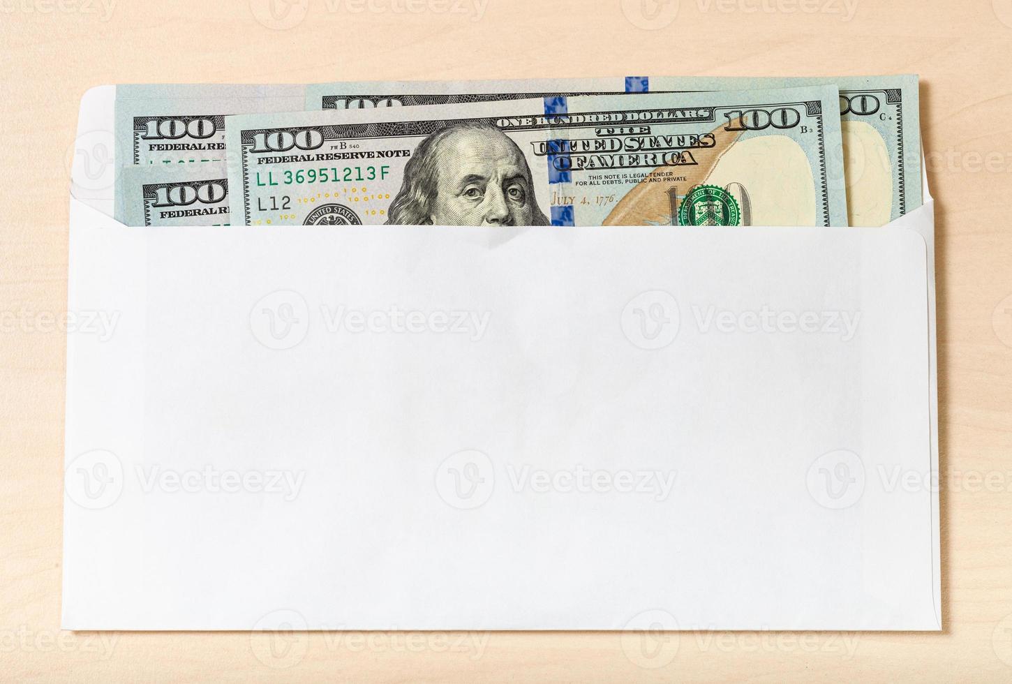 several one hundred-dollar bills in envelope photo