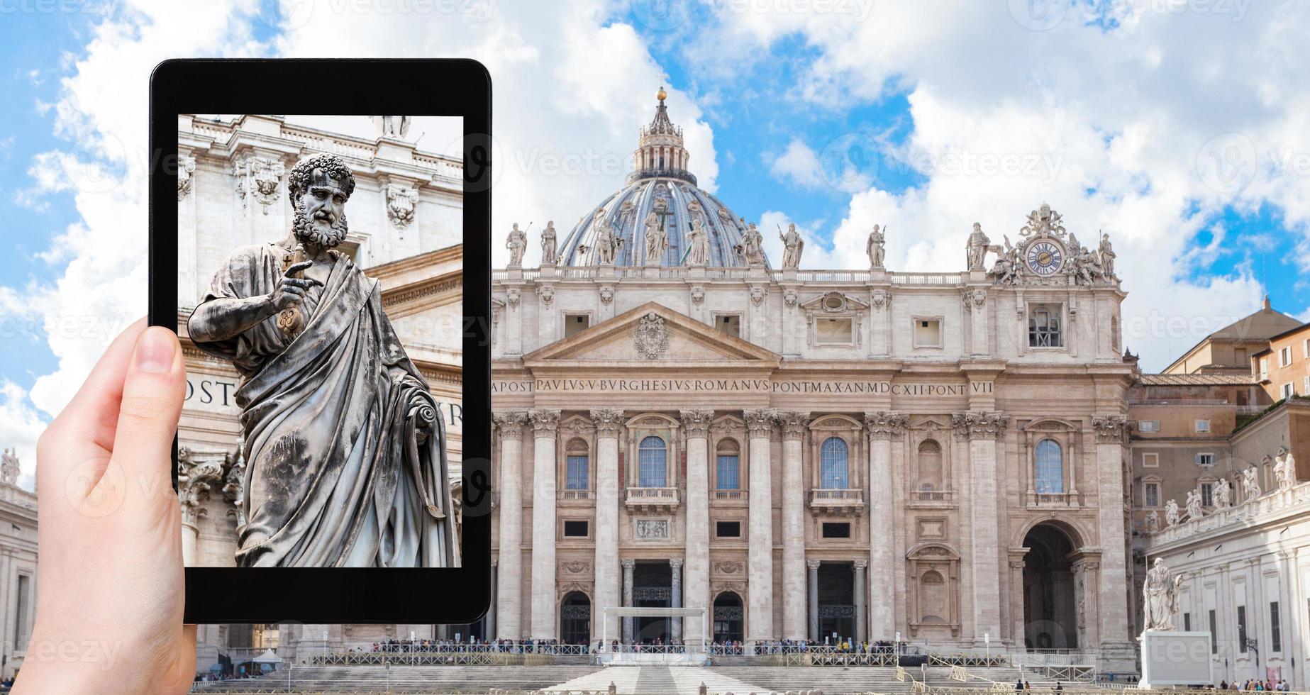 tourist photographs St Peter statue in Vatican photo