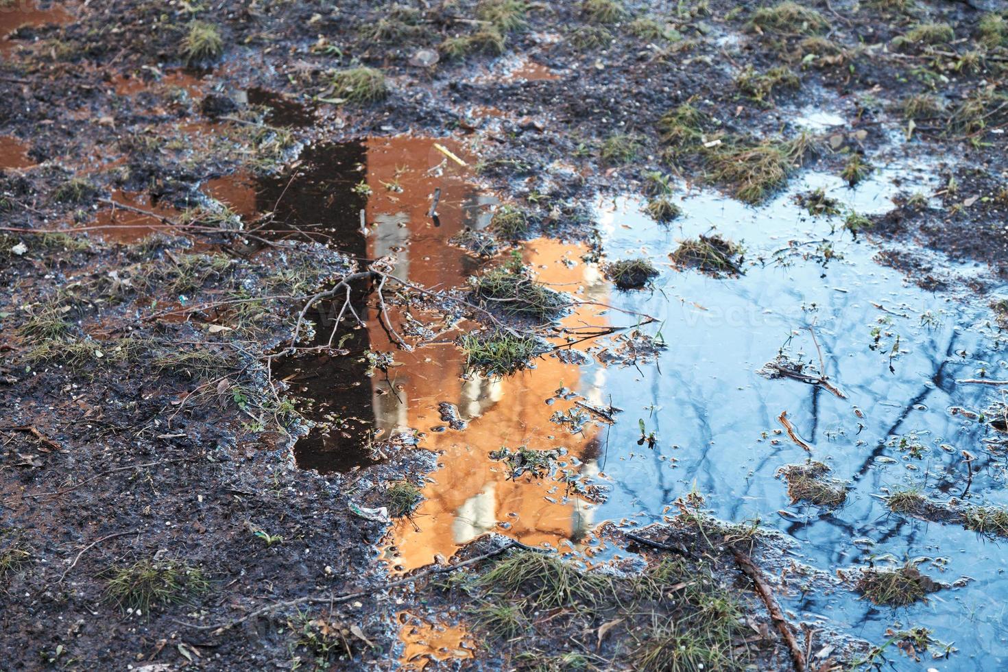 House reflection in the spring puddle photo