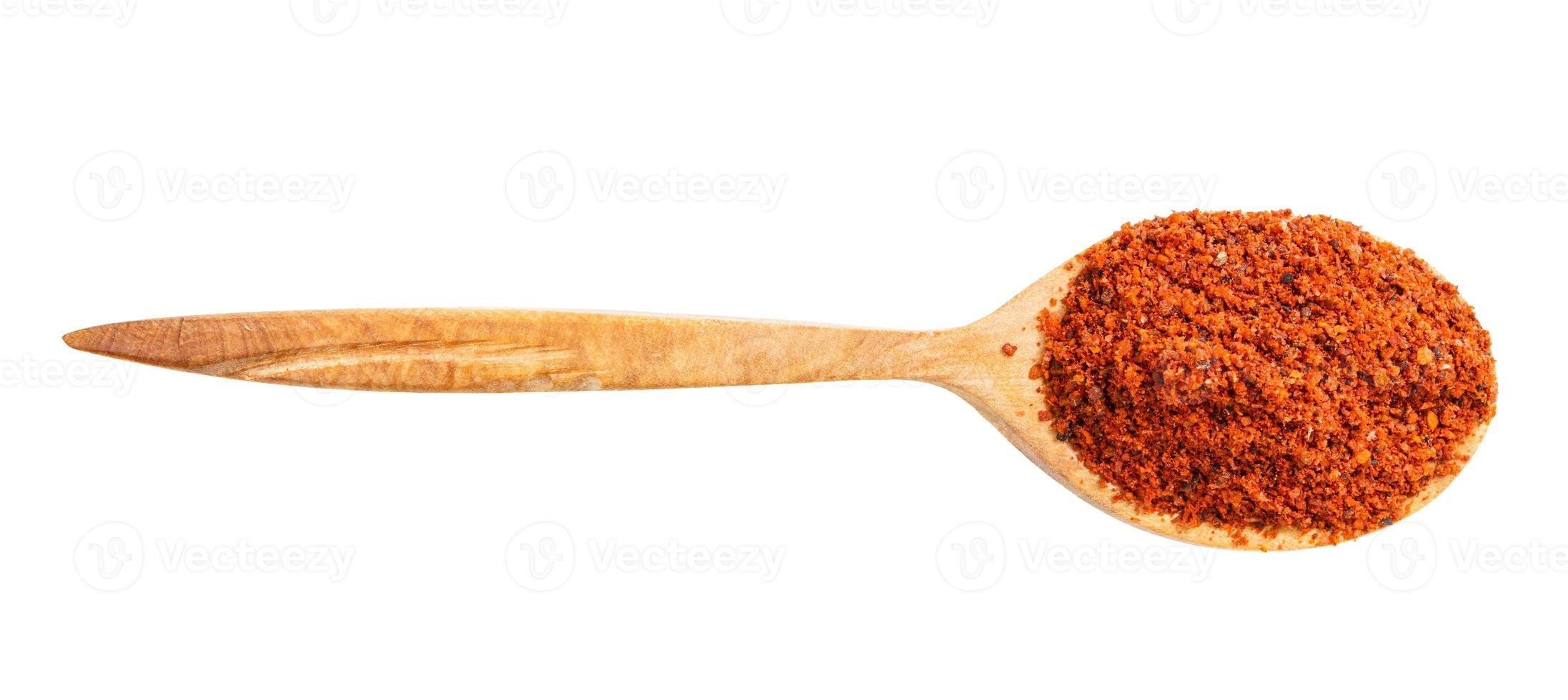 view of wood spoon with paprika powder isolated photo