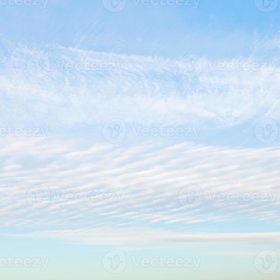 white cirrus clouds in blue afternoon sky photo