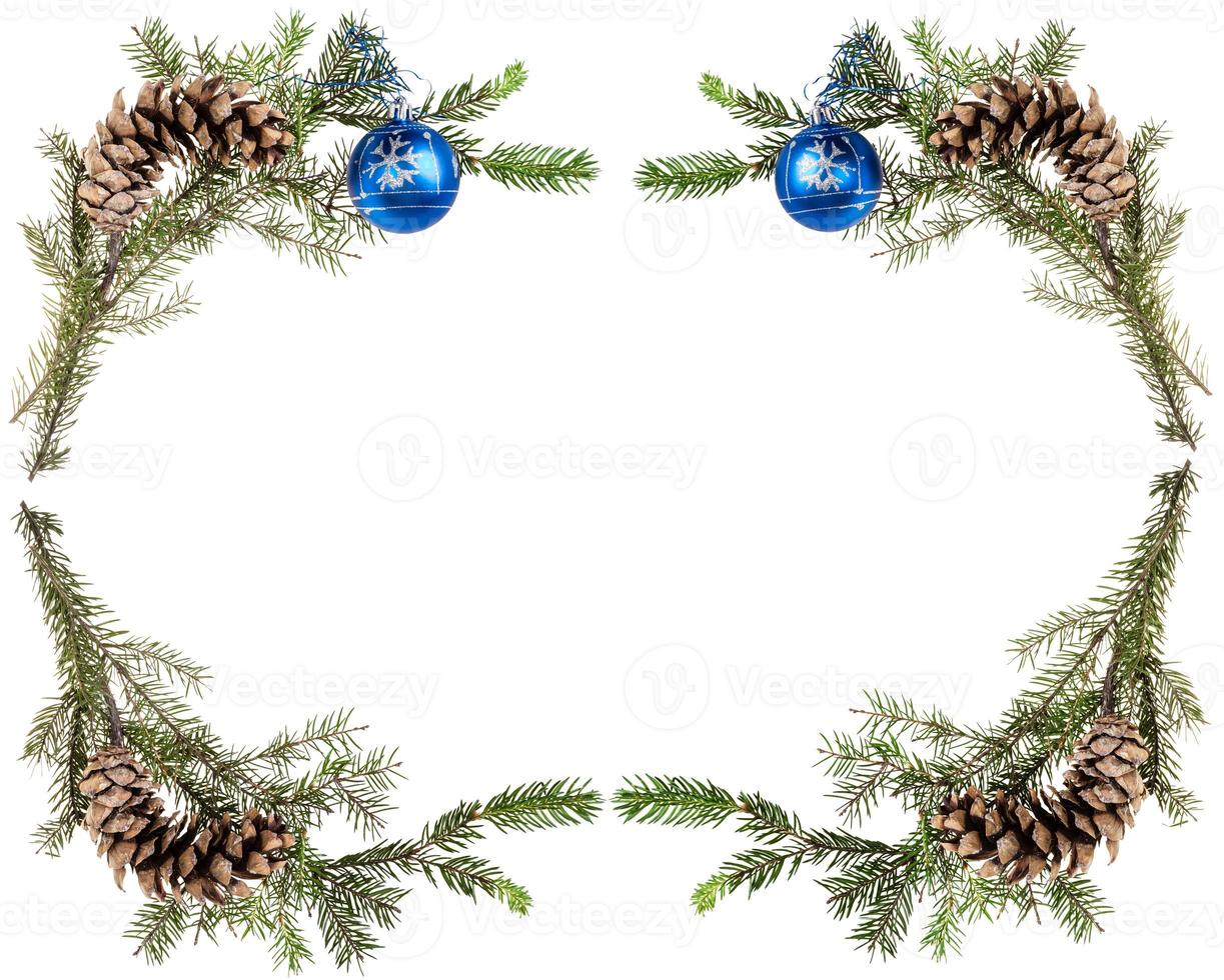 spruce twigs with cones and blue balls on white photo