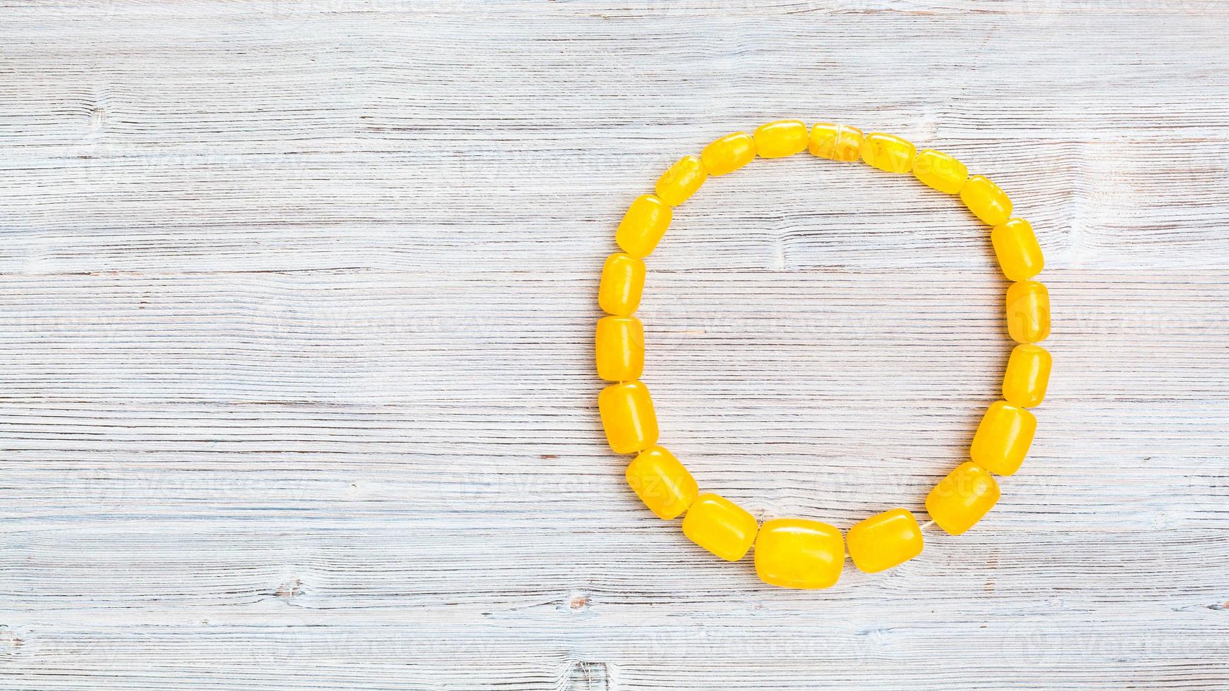 top view of vintage yellow amber necklace on gray photo