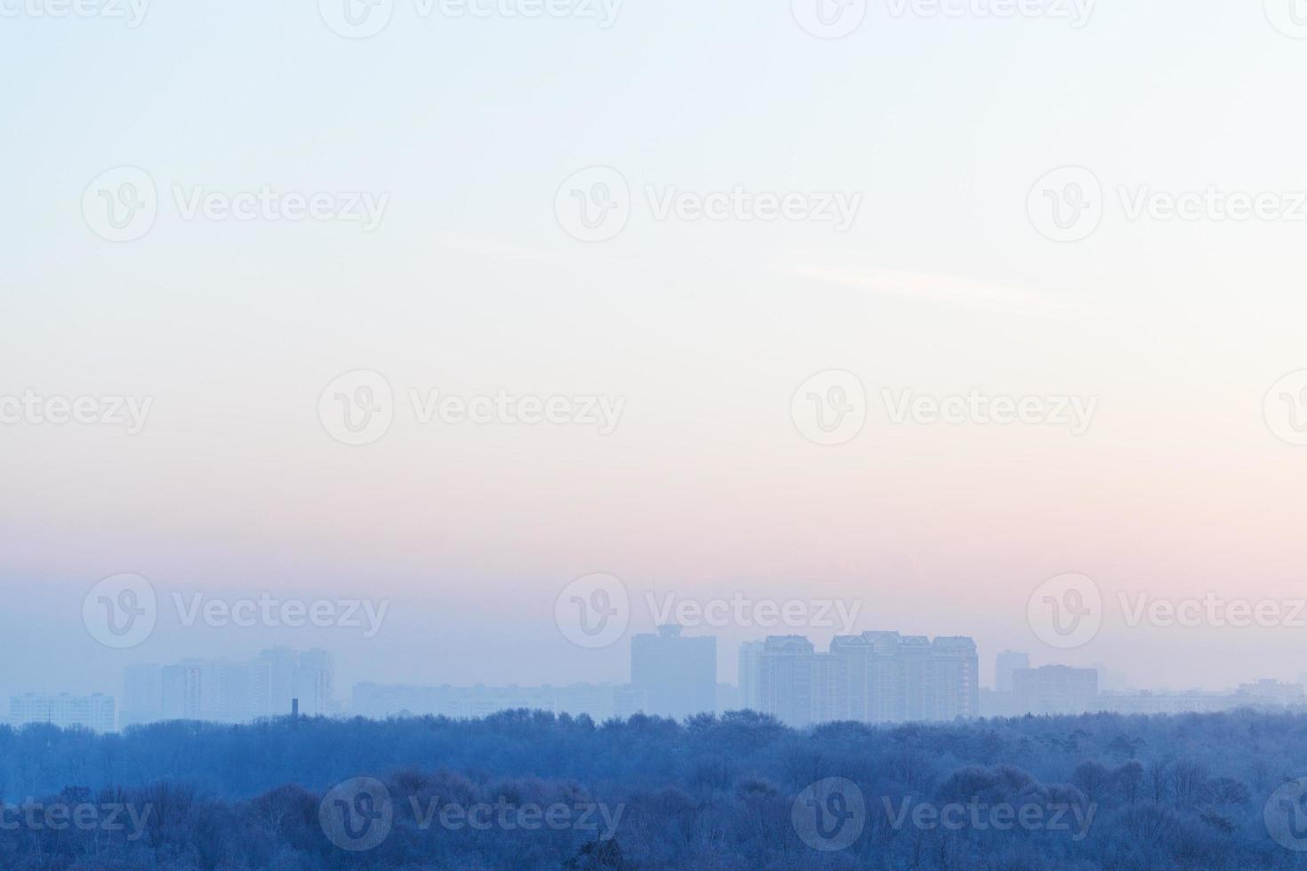 blue and pink sky over city in winter sunrise photo