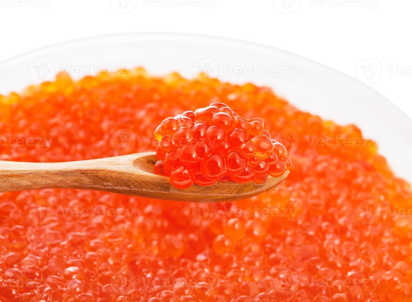 little wooden spoon with red caviar over bowl photo