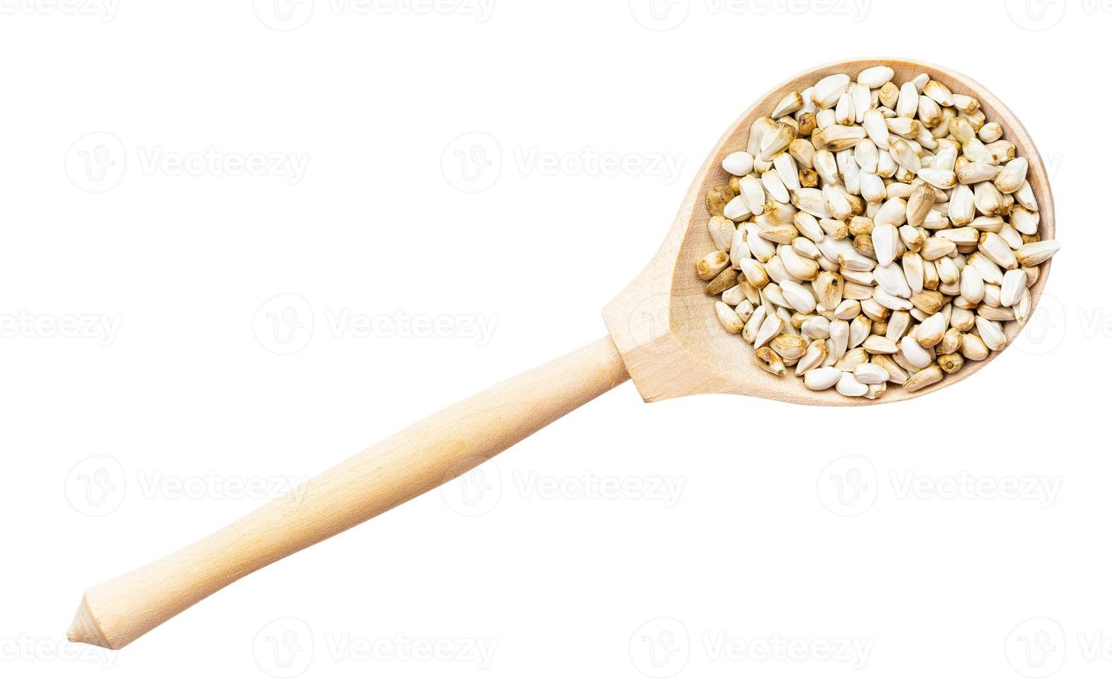 top view of safflower seeds in wood spoon isolated photo