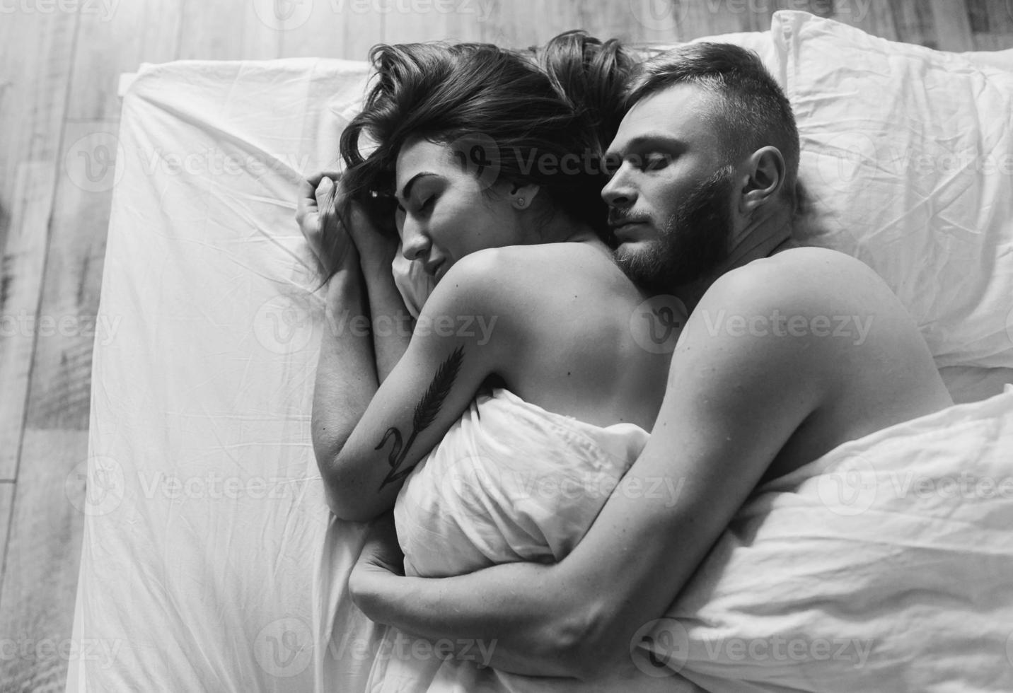 Young couple in bed together photo