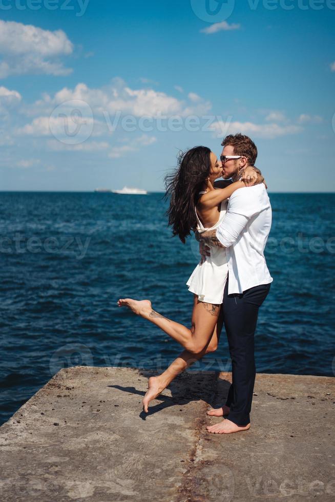 Guy and girl on the sea pier photo