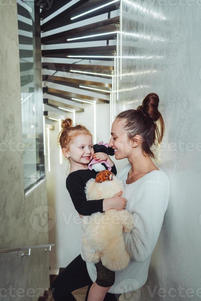 Mom and little daughter in their arms photo