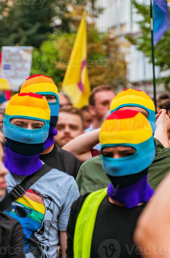 People in lgbt masks at an LGBT rally photo