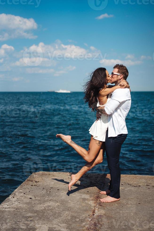 Guy and girl on the sea pier photo