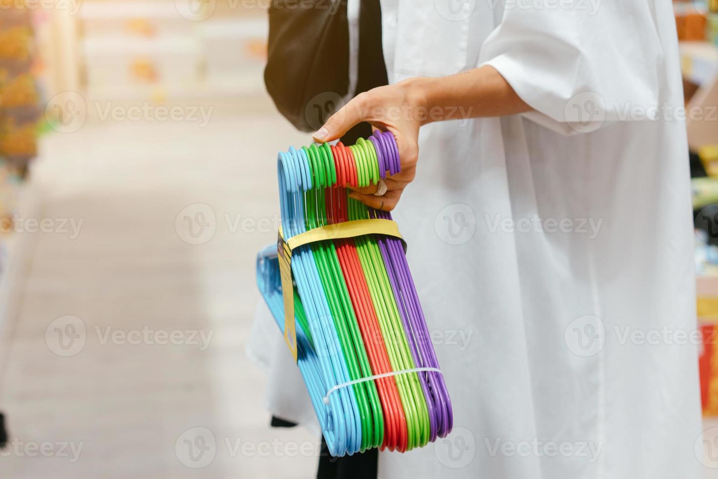 Female hand holding a set of hangers photo