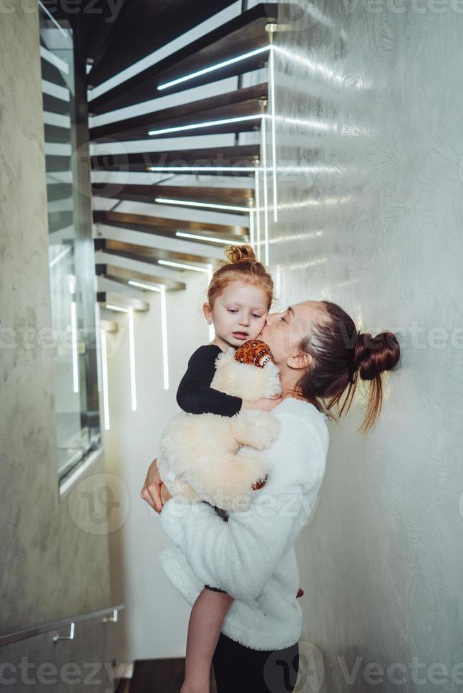 Mom and little daughter in their arms photo