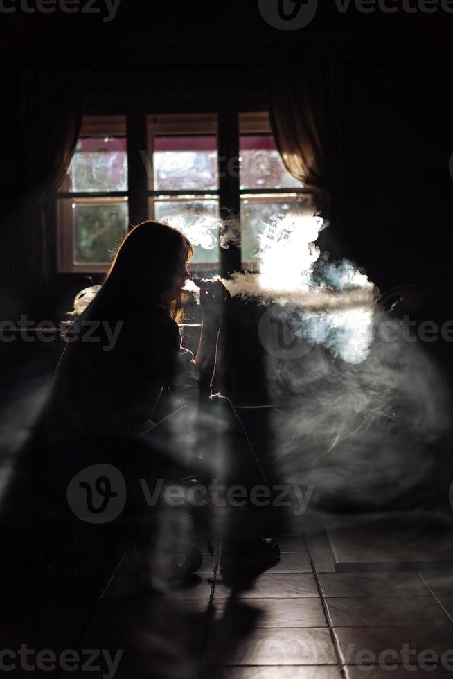 The girl smoke electronic cigarette photo