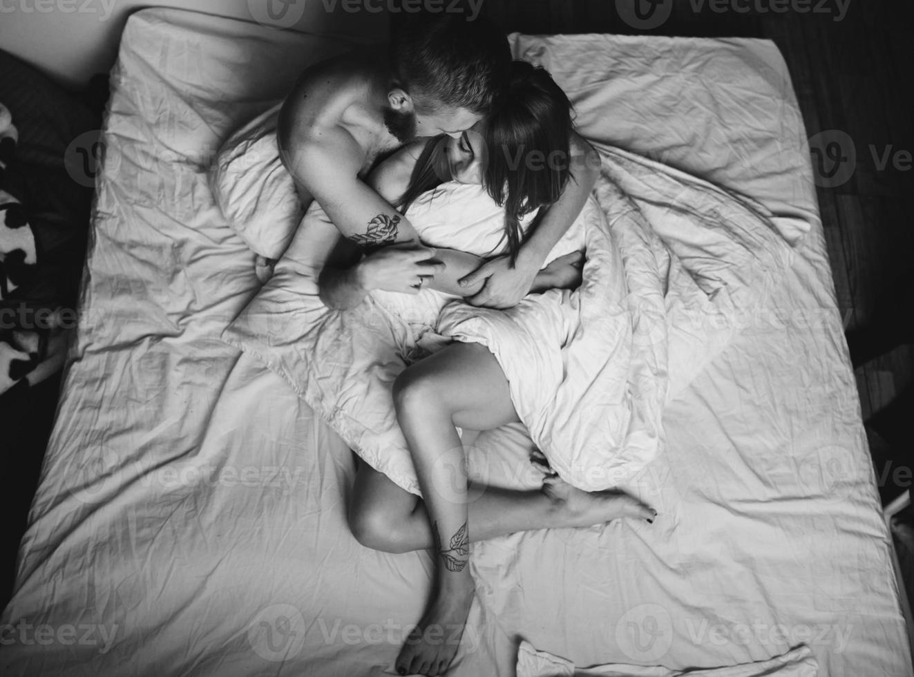 Young couple in bed together photo