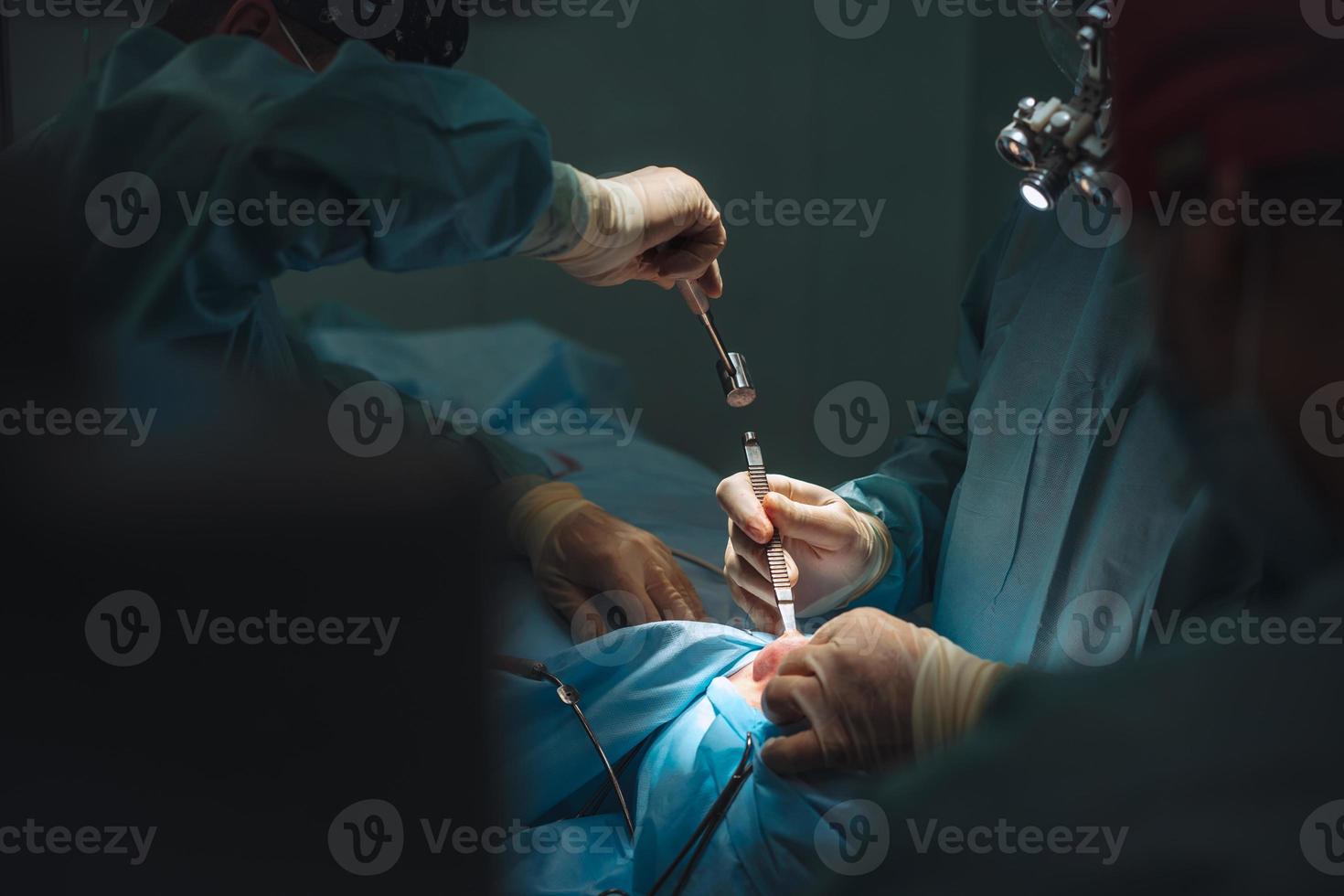 The surgeon uses a chisel and a hammer photo