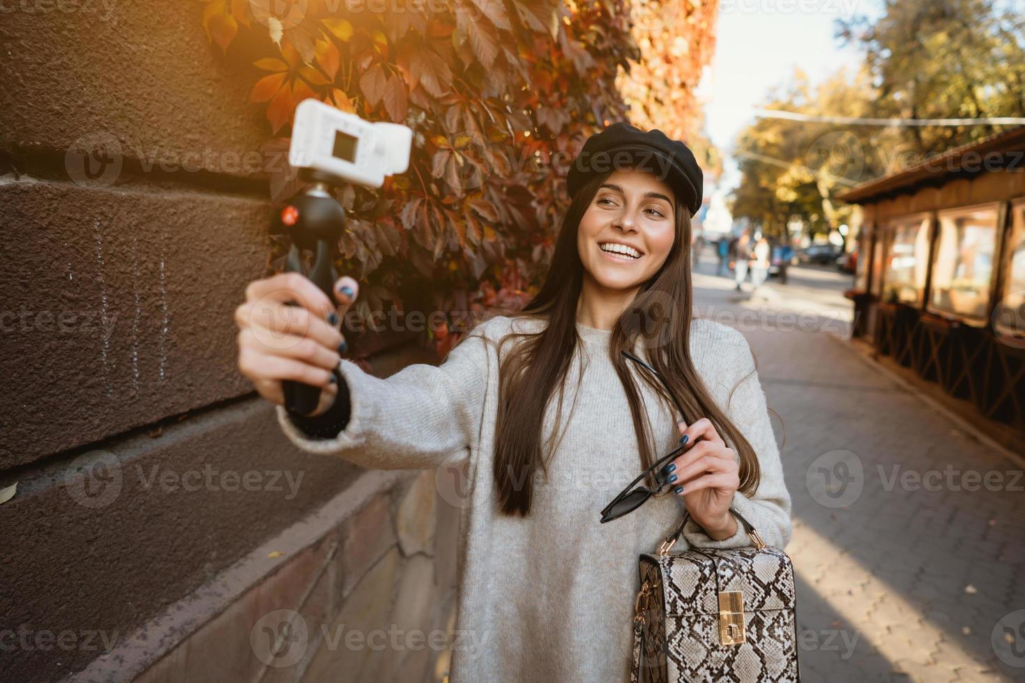 Cute, young girl makes selfie and posing on camera. photo