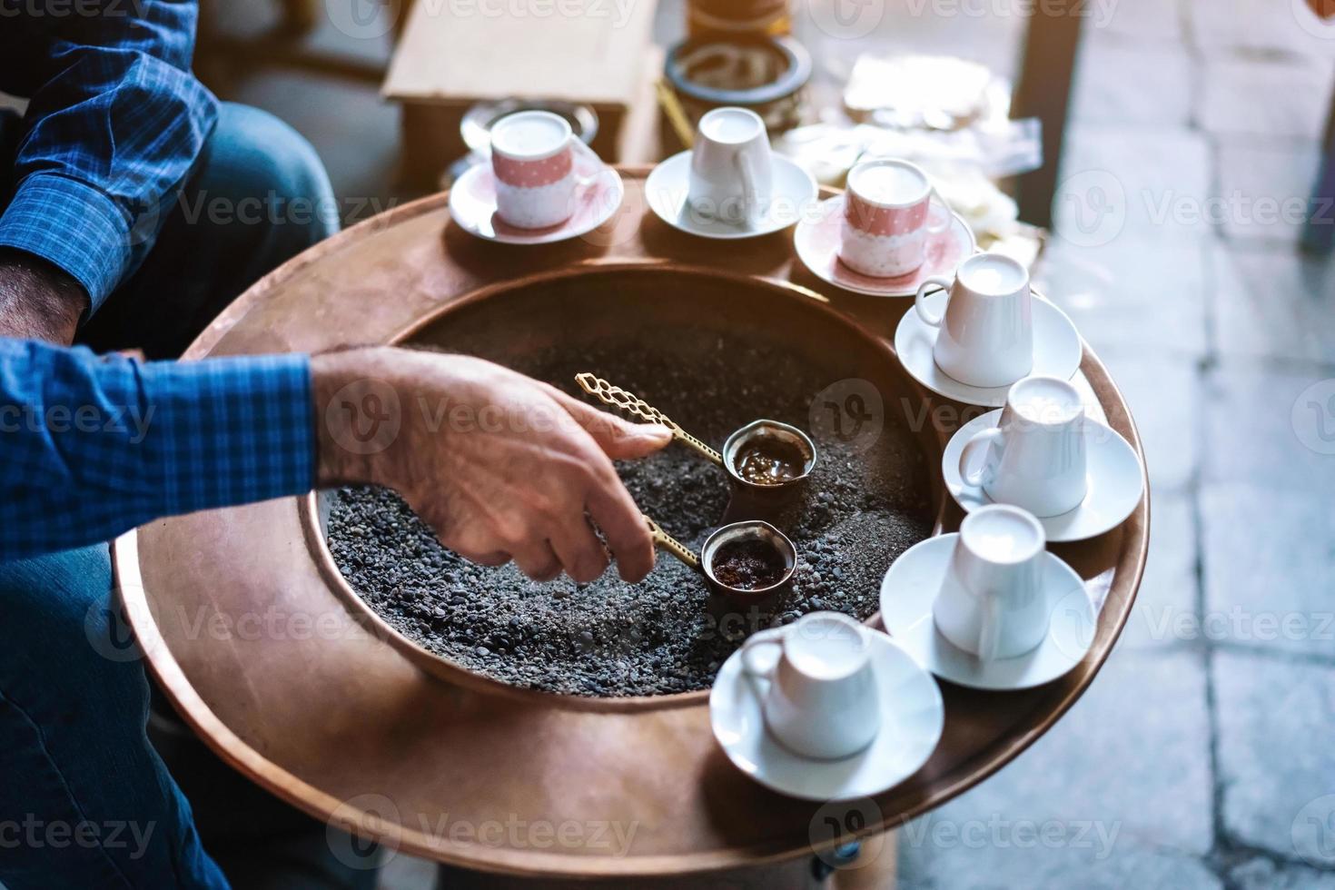 A man make Turkish coffee photo