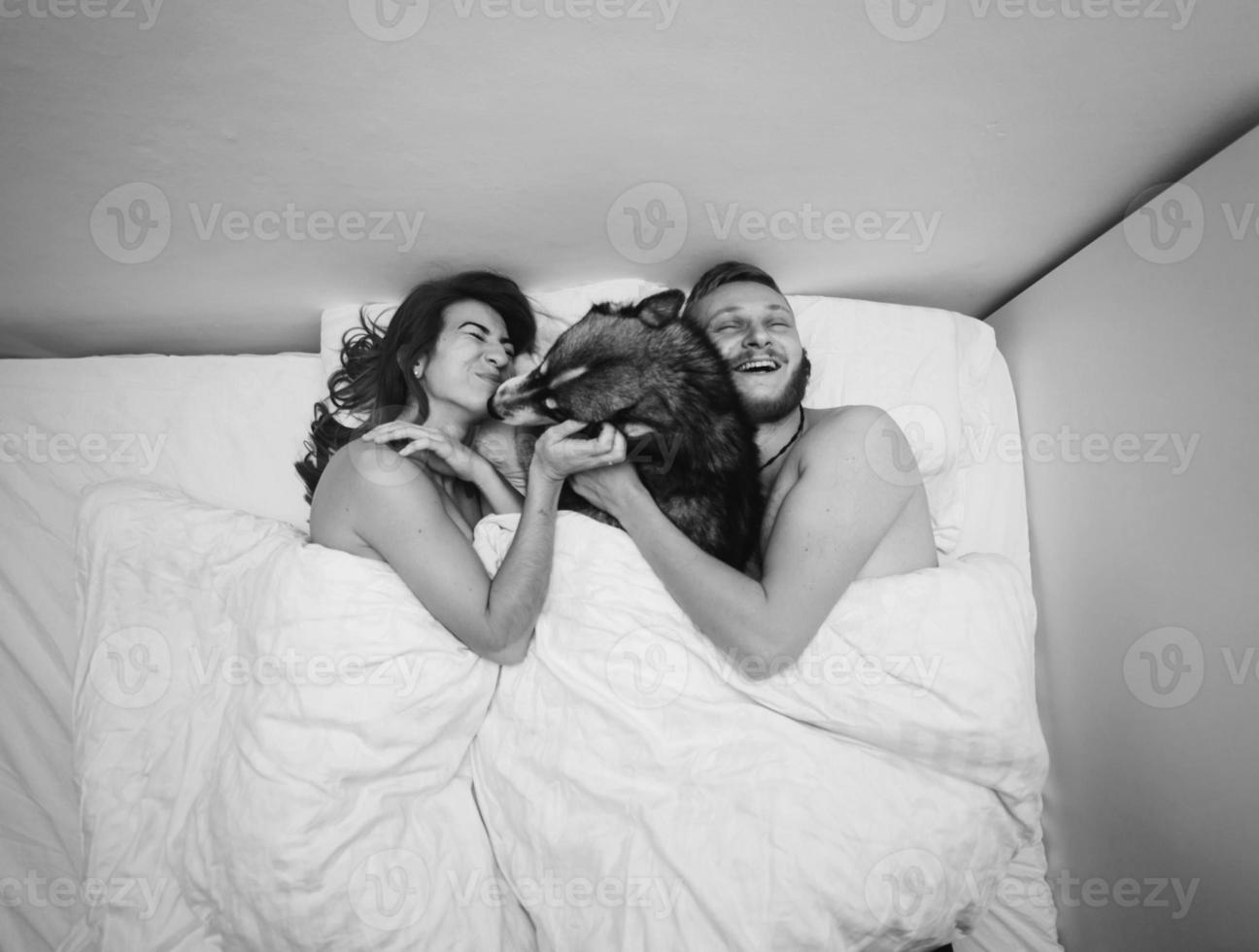 Young adult couple lying on bed photo