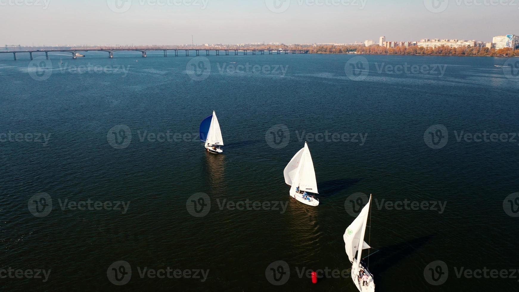 Sailboat sailing on early morning blue water river photo