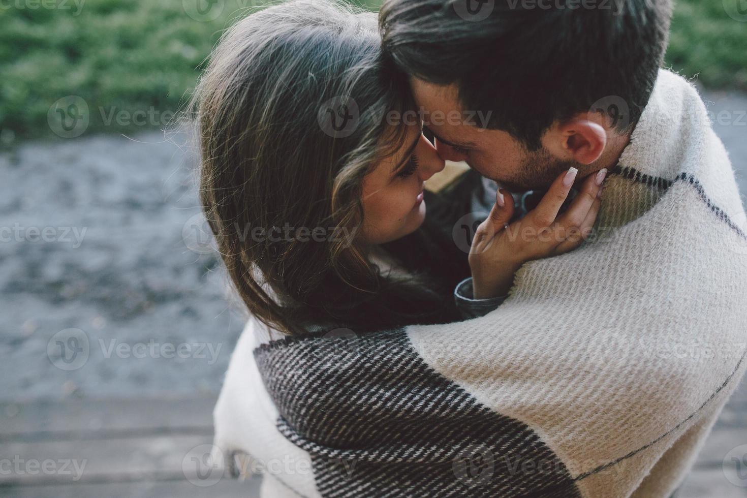 Young couple wrapped in plaid photo