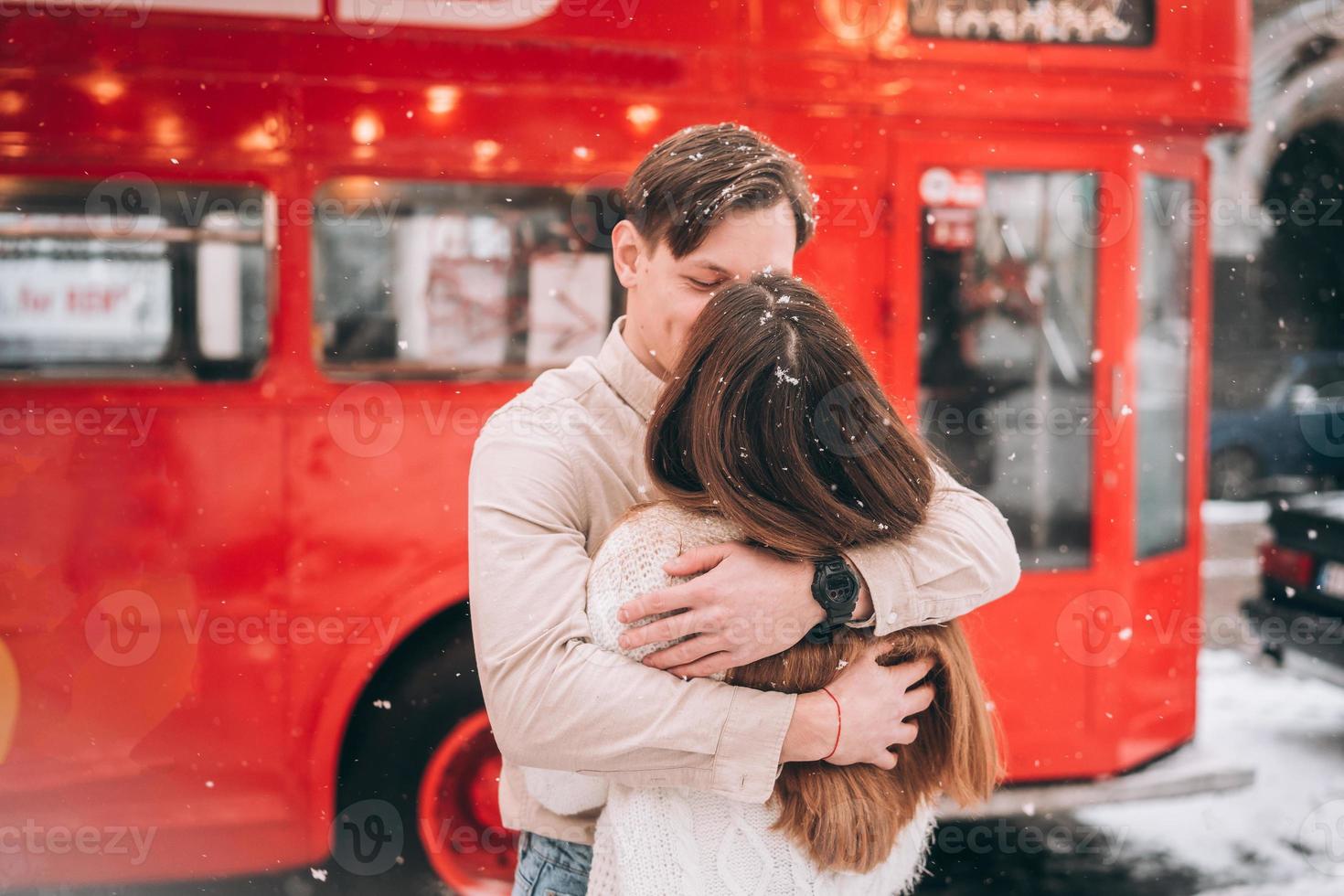 beautiful young couple posing by the old bus photo