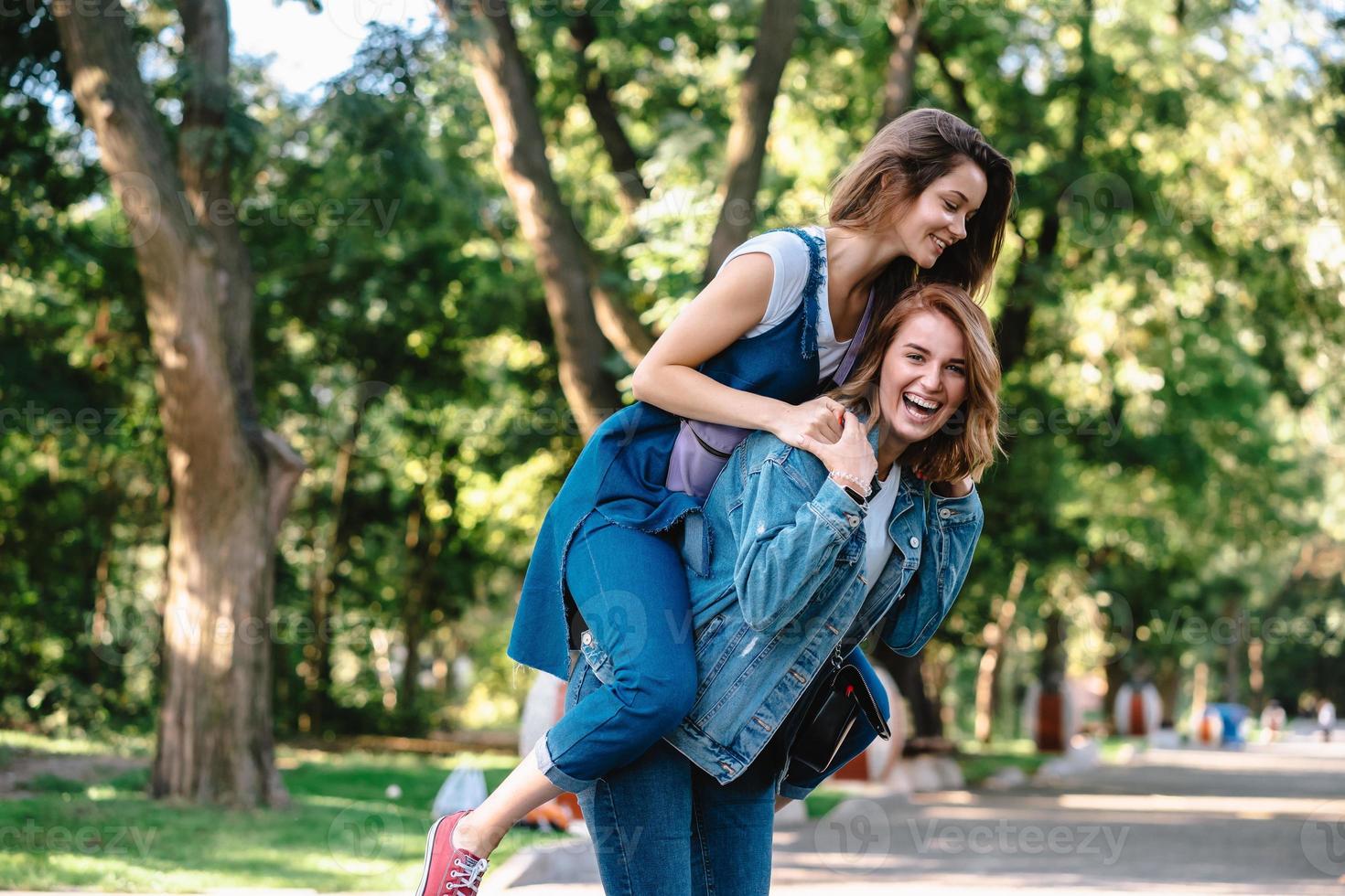 Beautiful women having fun in the park. Friends and summer concept. photo