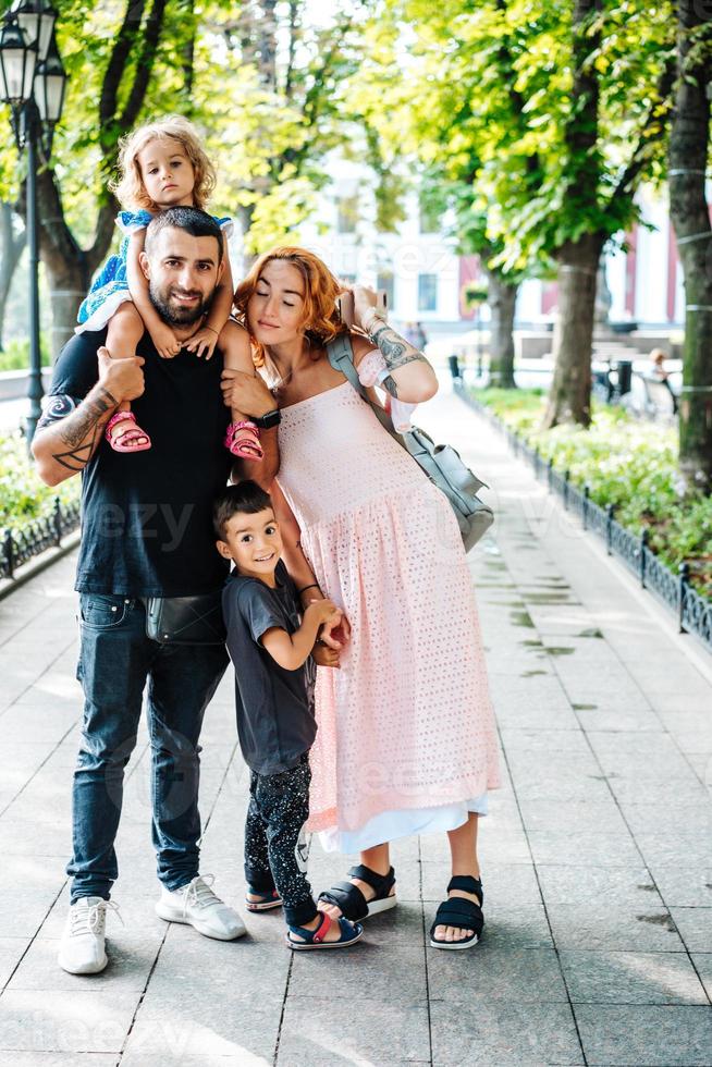 Happy beautiful family walking in the park photo