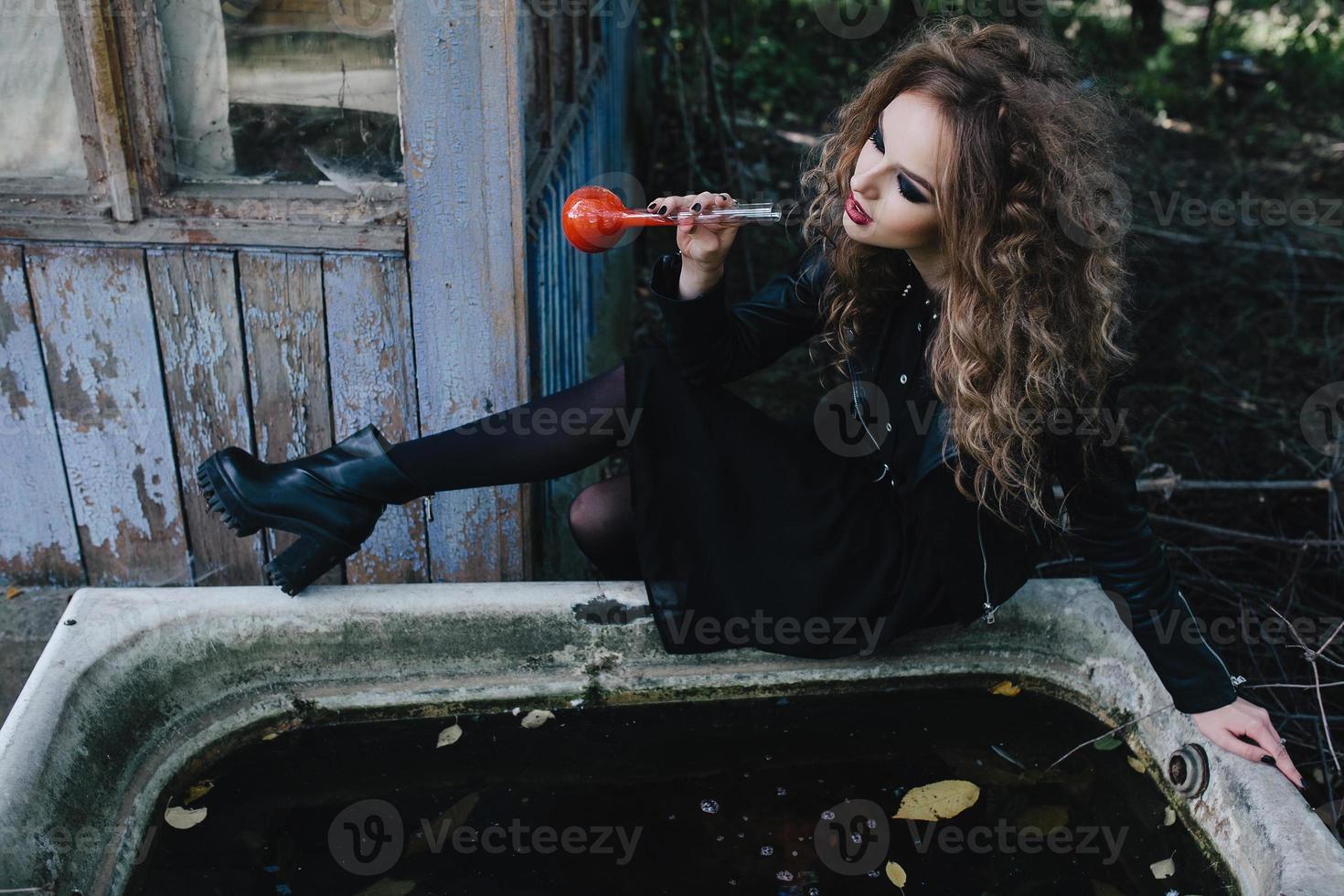Vintage witch with elixir in hand photo