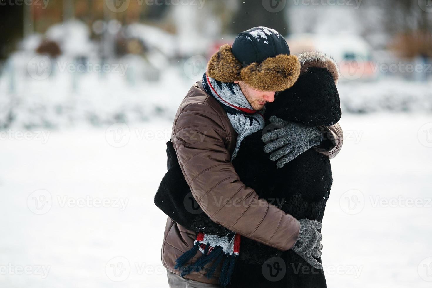 beautiful couple on a frozen lake photo