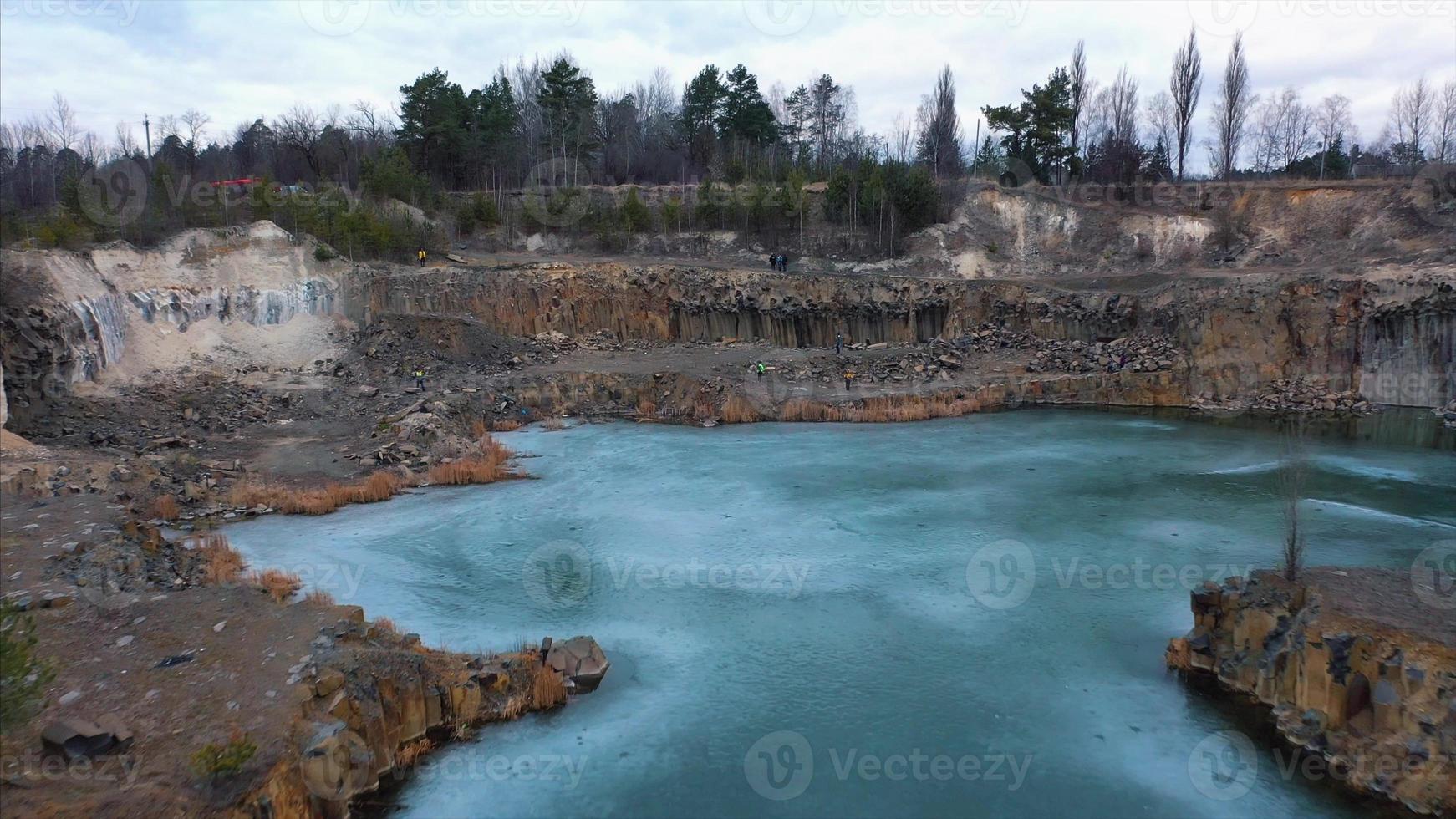 Beautiful quarry, the lake is covered with thin ice photo