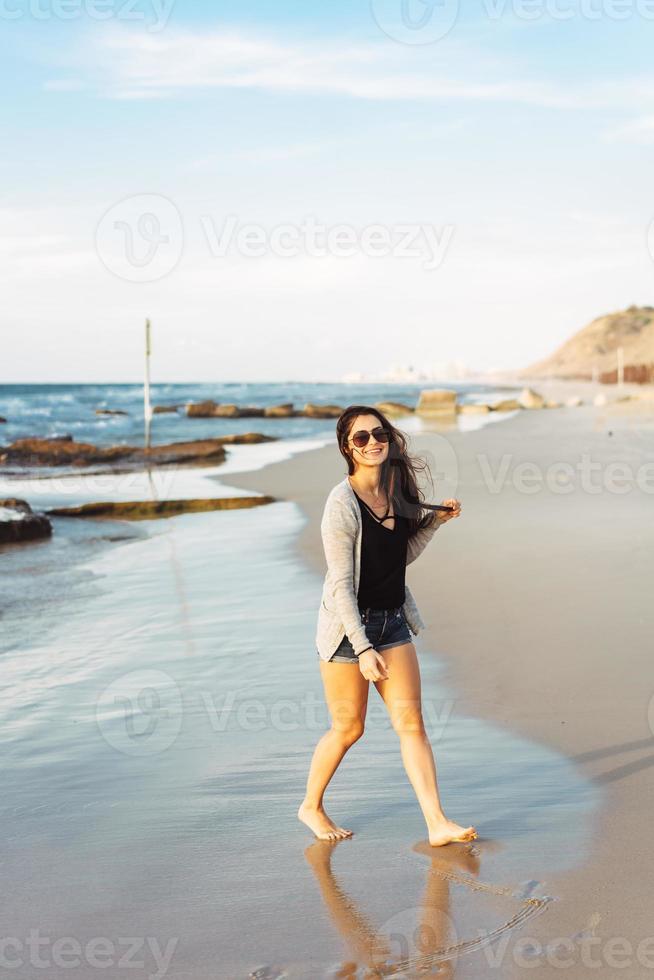 Young beautiful girl posing by the sea photo