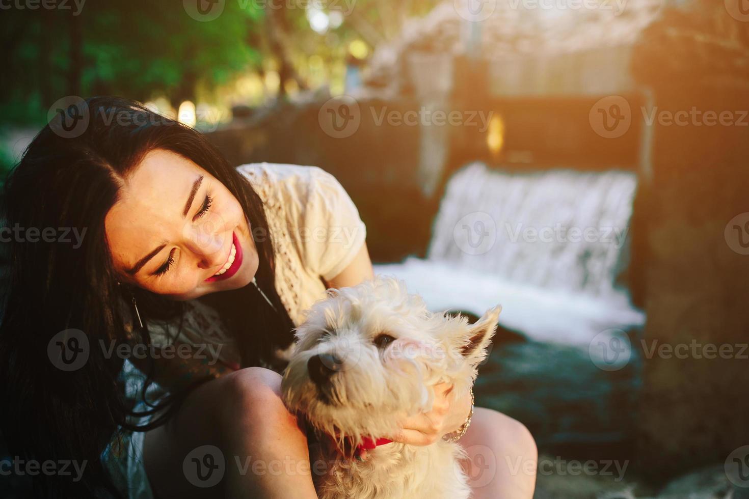 girl playing with a dog photo