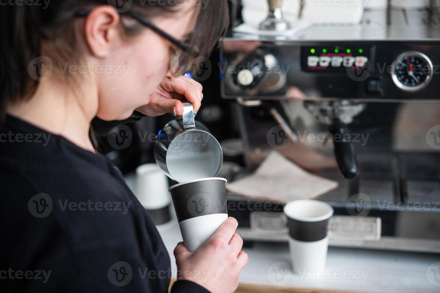 Female barista makes coffee photo