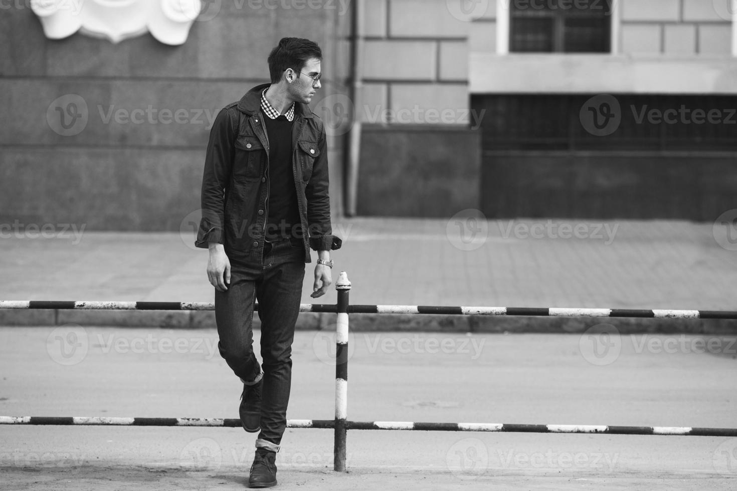 A man dressed in jeans on the background of the old city photo