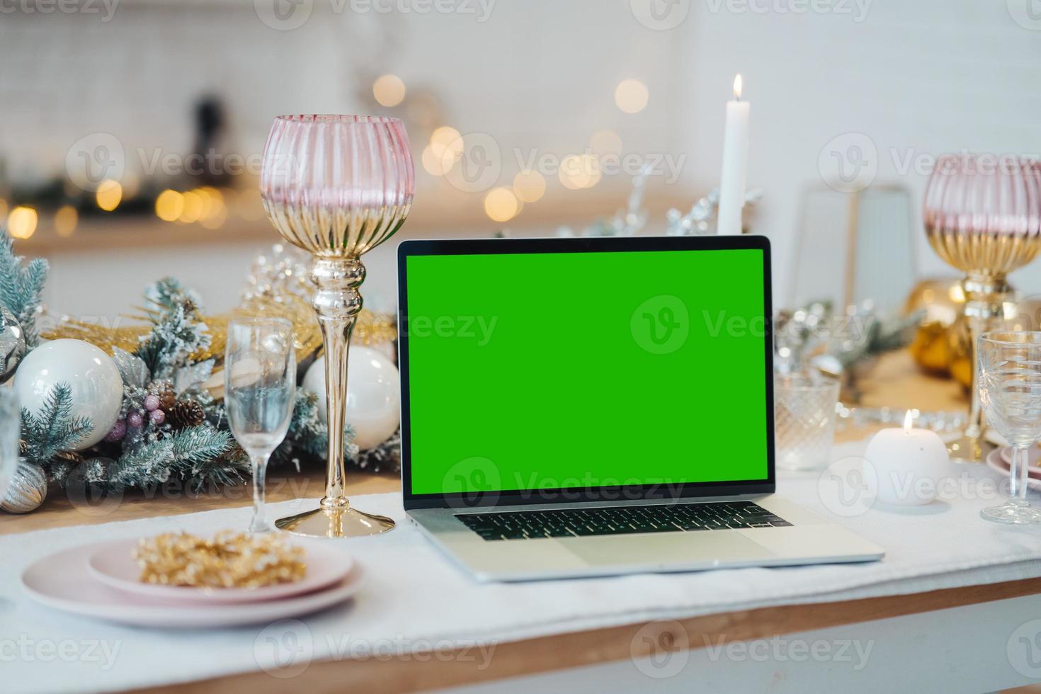 laptop with green screen - chromakey near New Year's decorations. christmas theme. photo