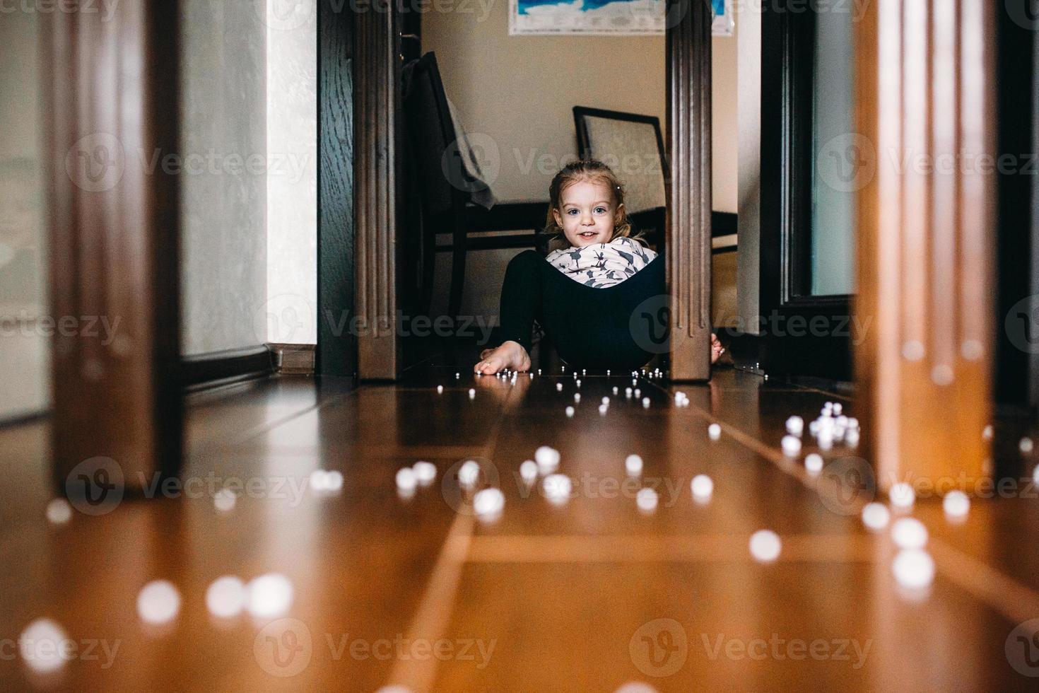 Little girl is playing with foam balls photo