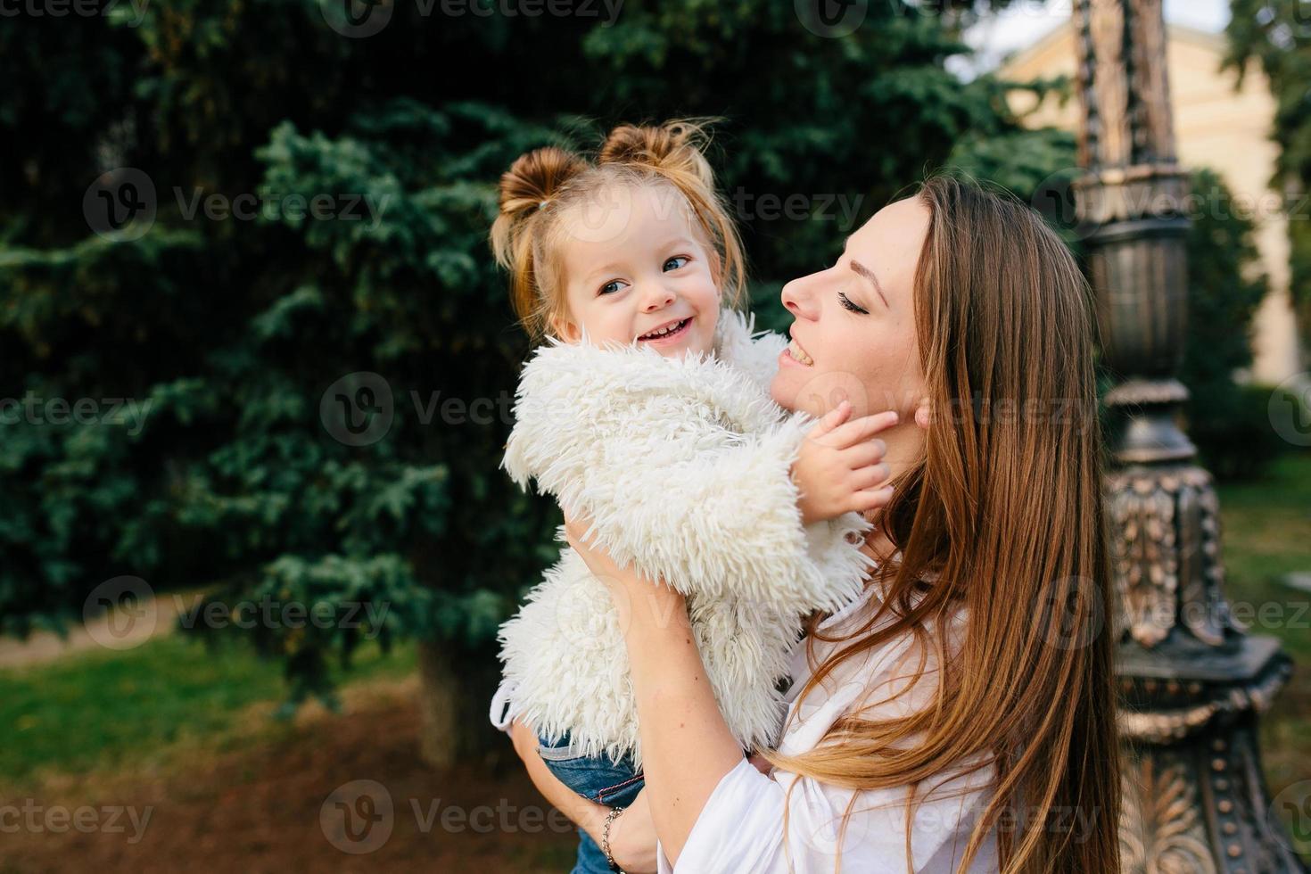 Mother and little daughter in a park photo