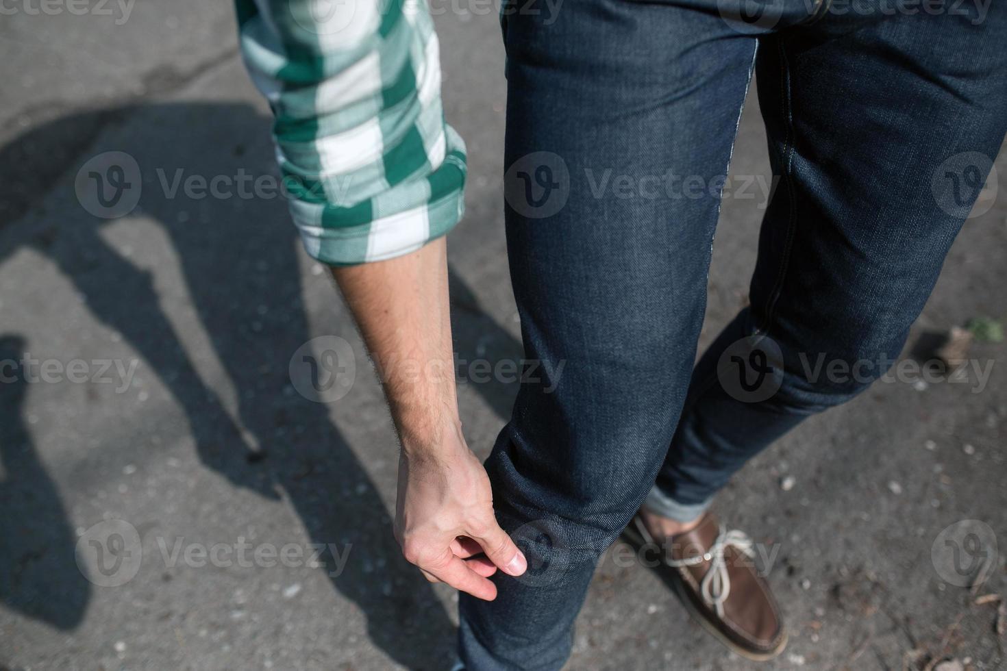 Feet of the man in the authentic boots and  selvedge jeans photo