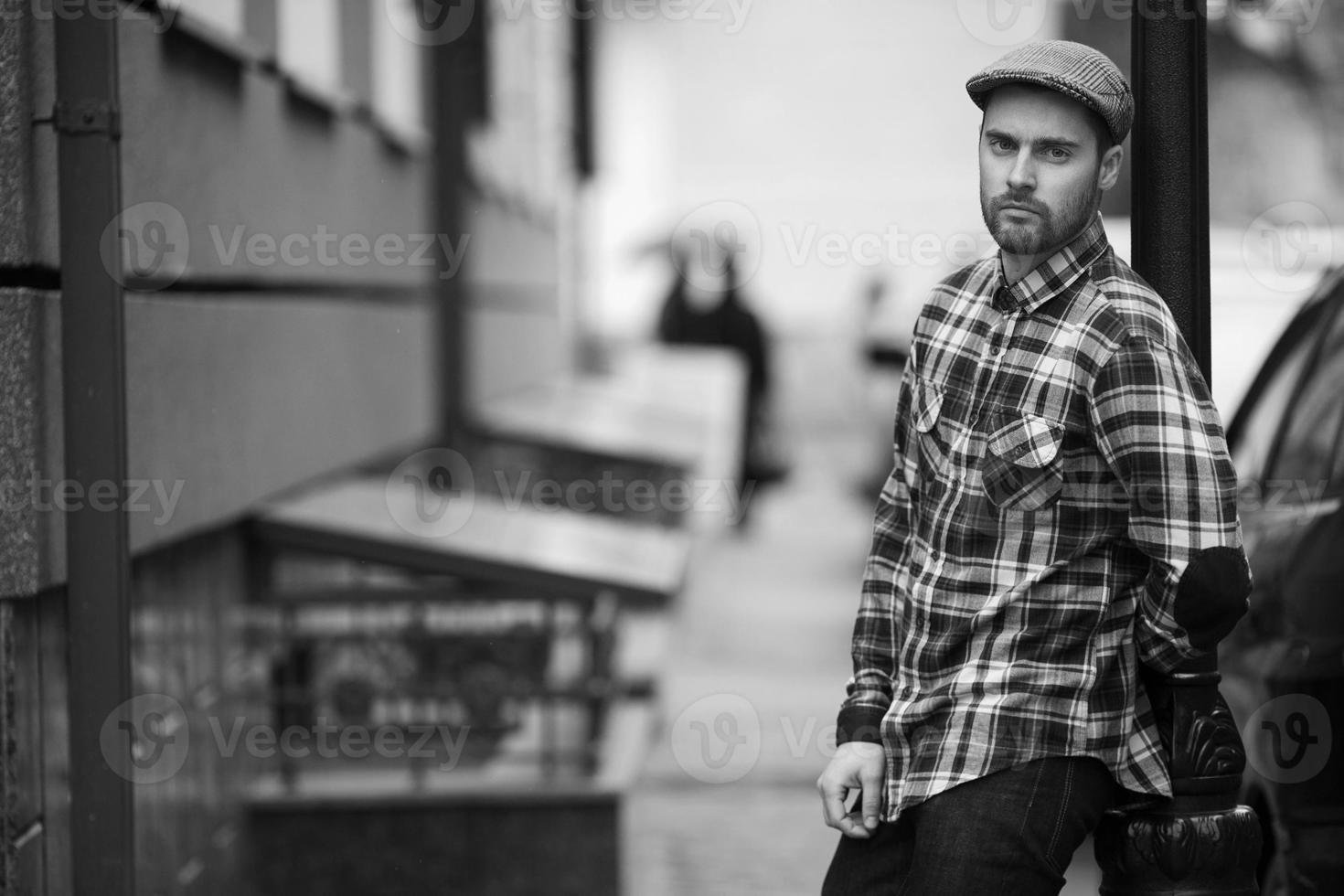 The man in the authentic boots and selvedge jeans  on a background of old city photo