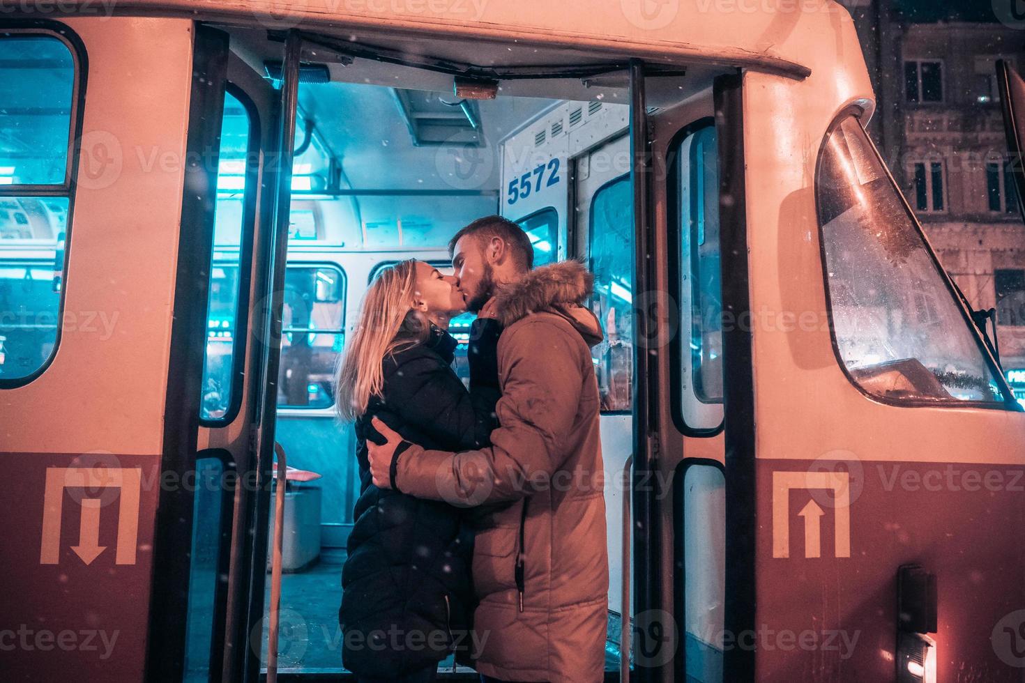 The guy and the girl kiss on the tram photo