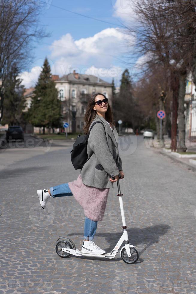Young girl posing on a scooter photo