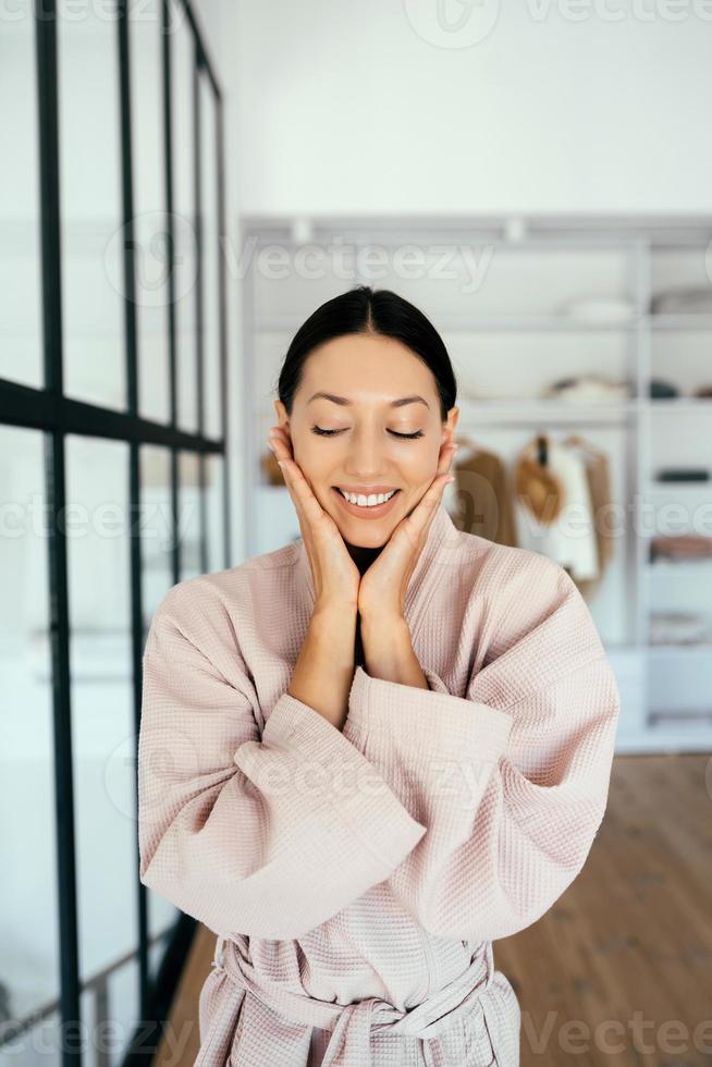 Portrait of a beautiful healthy woman in bathrobe indoors photo